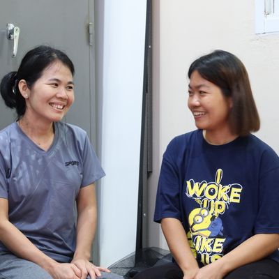 Two women smiling to each other.