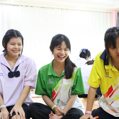 The students are smiling while attending the workshop.