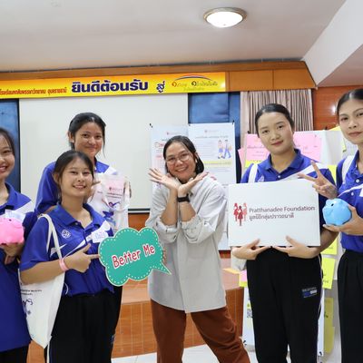 Group of students and teacher are smiling at the camera