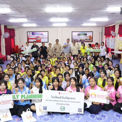 Group of students and teacher are smiling at the camera