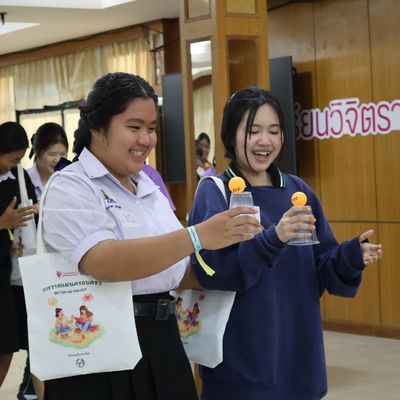 The students are smiling while attending the workshop.