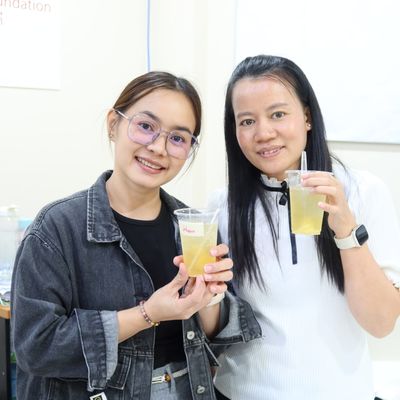 PND students are showing their beverage, smiling at the camera.