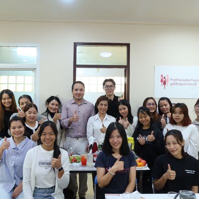 PND volunteers with students at the Better Me Connect Day workshop, smiling for the camera.