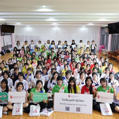 Group of students and teacher are smiling at the camera