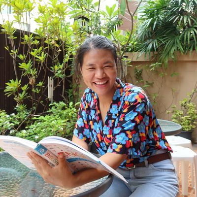 Muay is reading an English book.