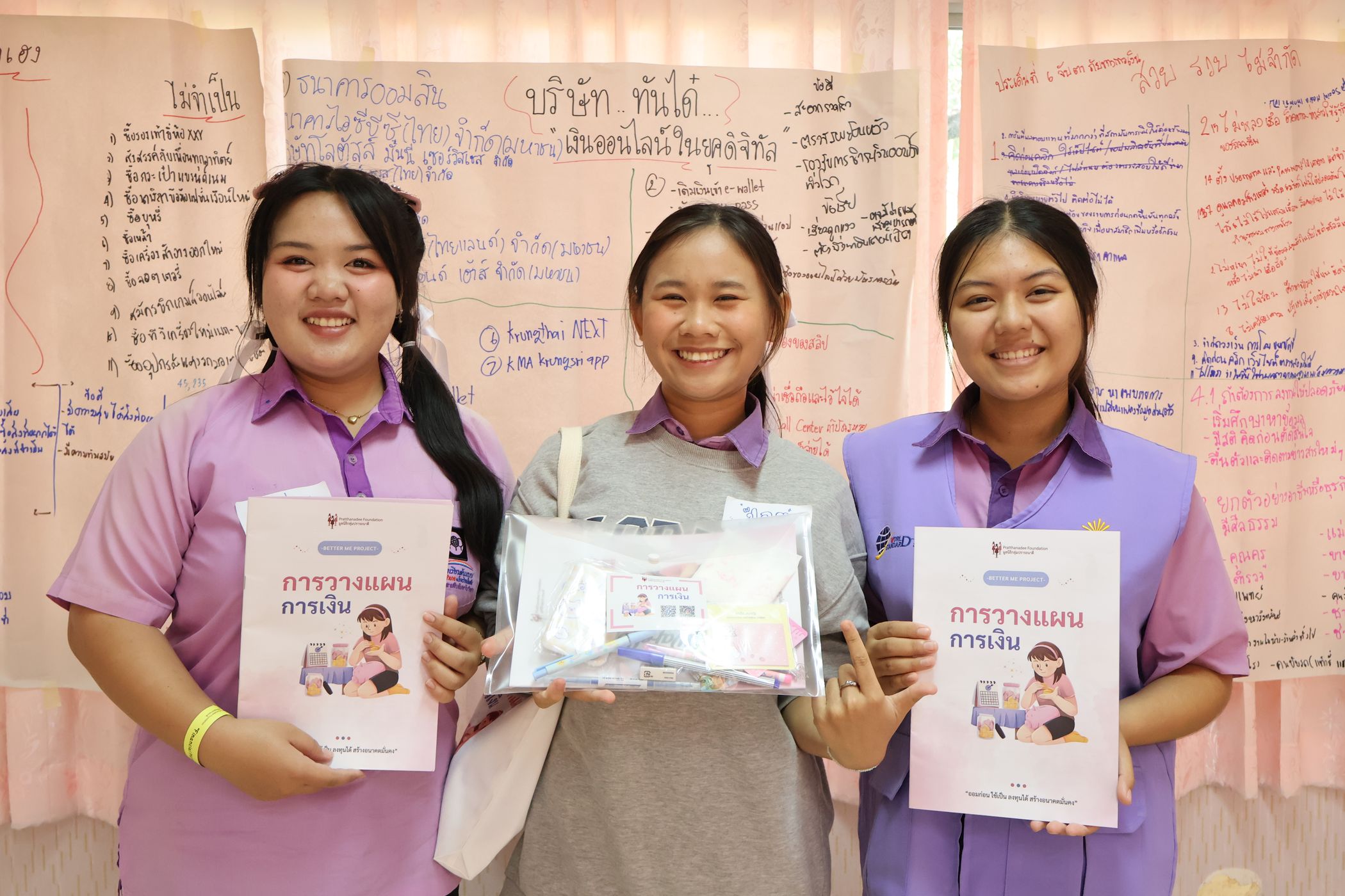 Students are happily smiling for the camera.