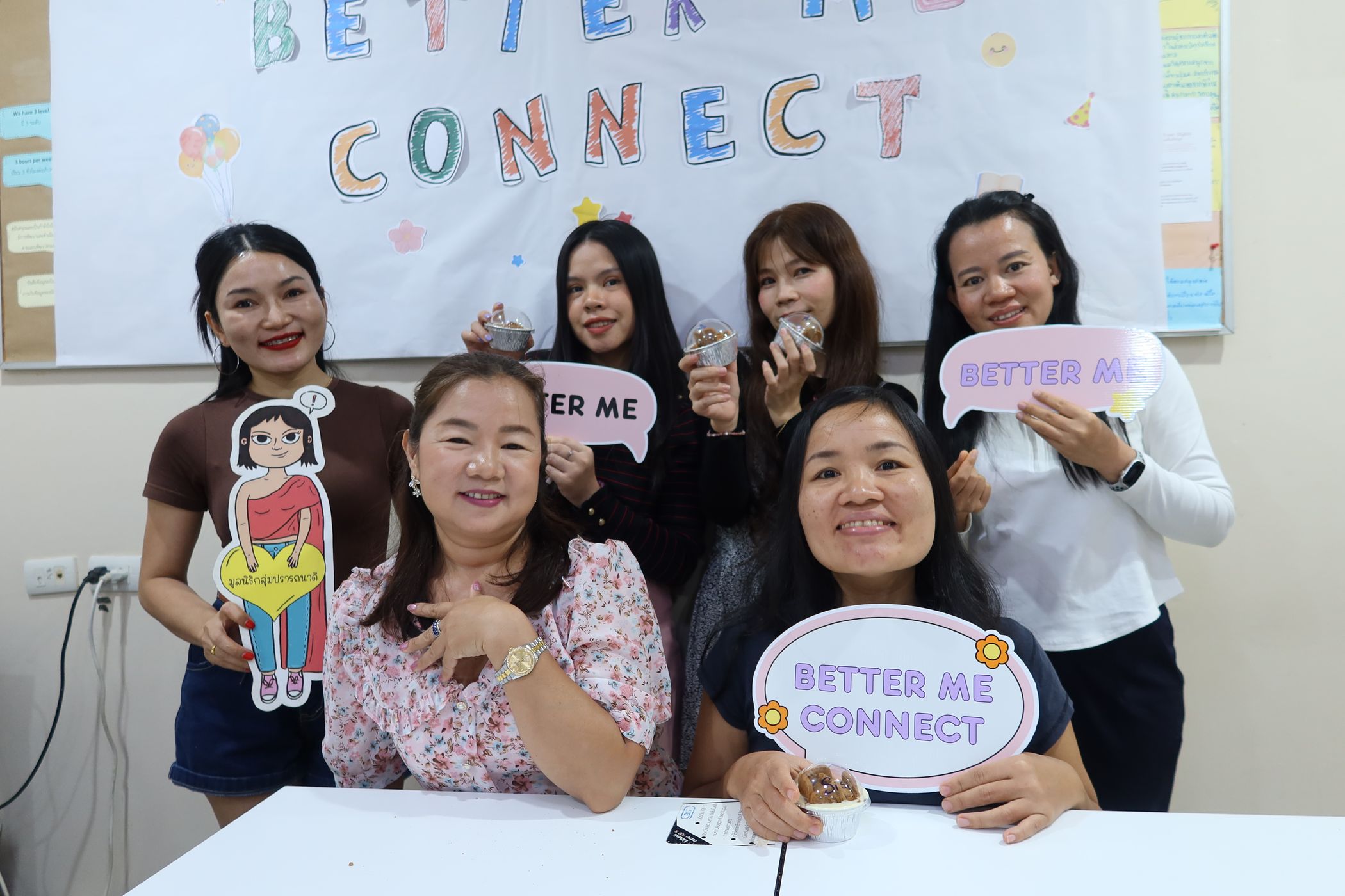 The women are smiling for the camera.