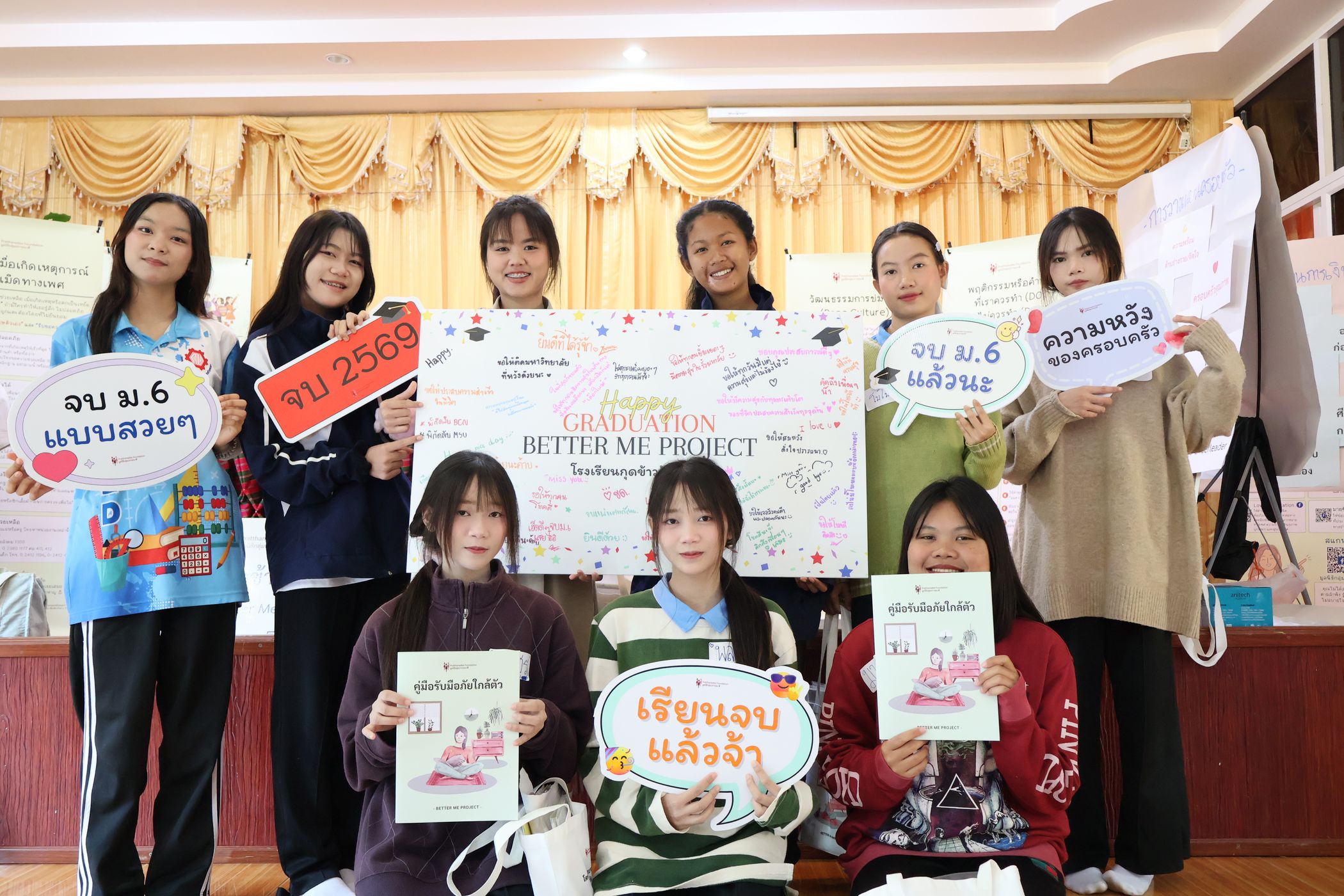 The students are happily smiling for the camera.