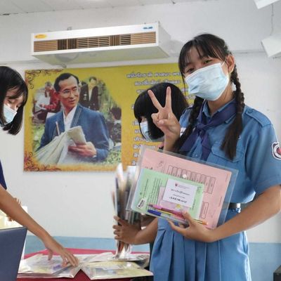 A girls is showing student self-learning kits for the camera.