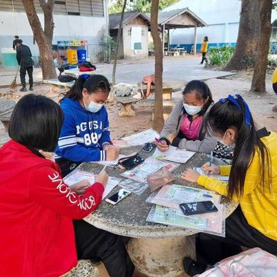 The students are writing on a sheet.