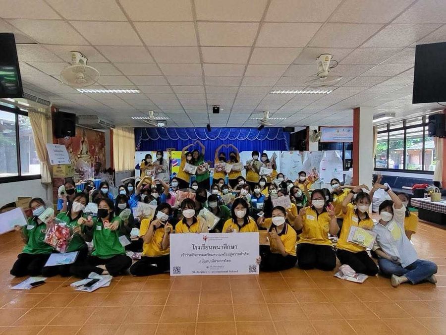 Group of students and teacher are smiling at the camera